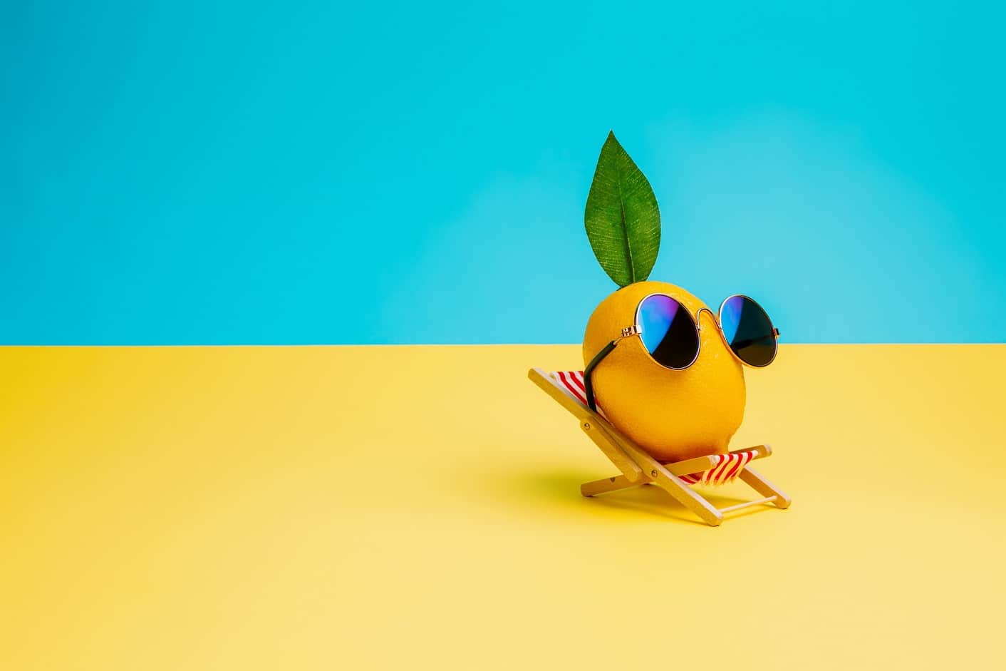 Lemon,Fruit,Chilling,In,Beach,Chair,On,The,Blue,And