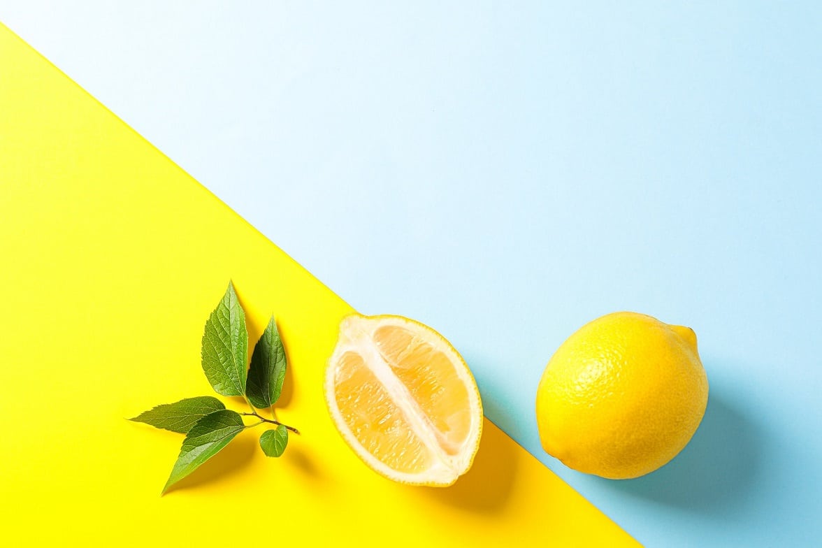 Flat,Lay,Composition,With,Lemons,On,Two,Tone,Background,,Space