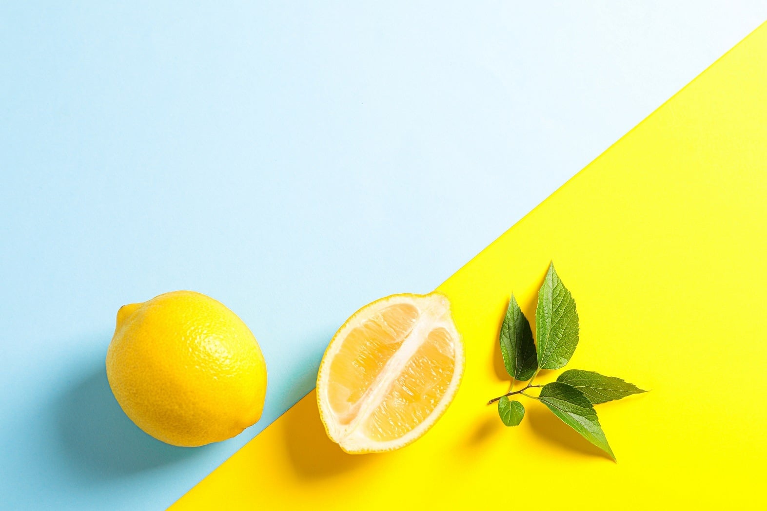 Flat,Lay,Composition,With,Lemons,On,Two,Tone,Background,,Space